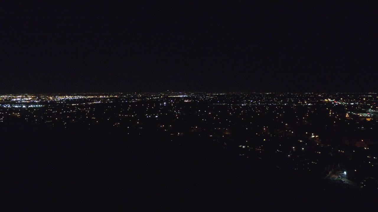 Second frame shows Denver at night from a high, wide viewpoint, with bright light clusters near the horizon and no visible people.