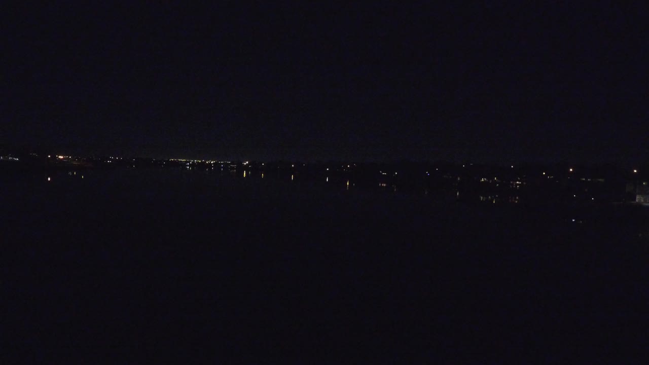 Dark aerial horizon with scattered distant lights