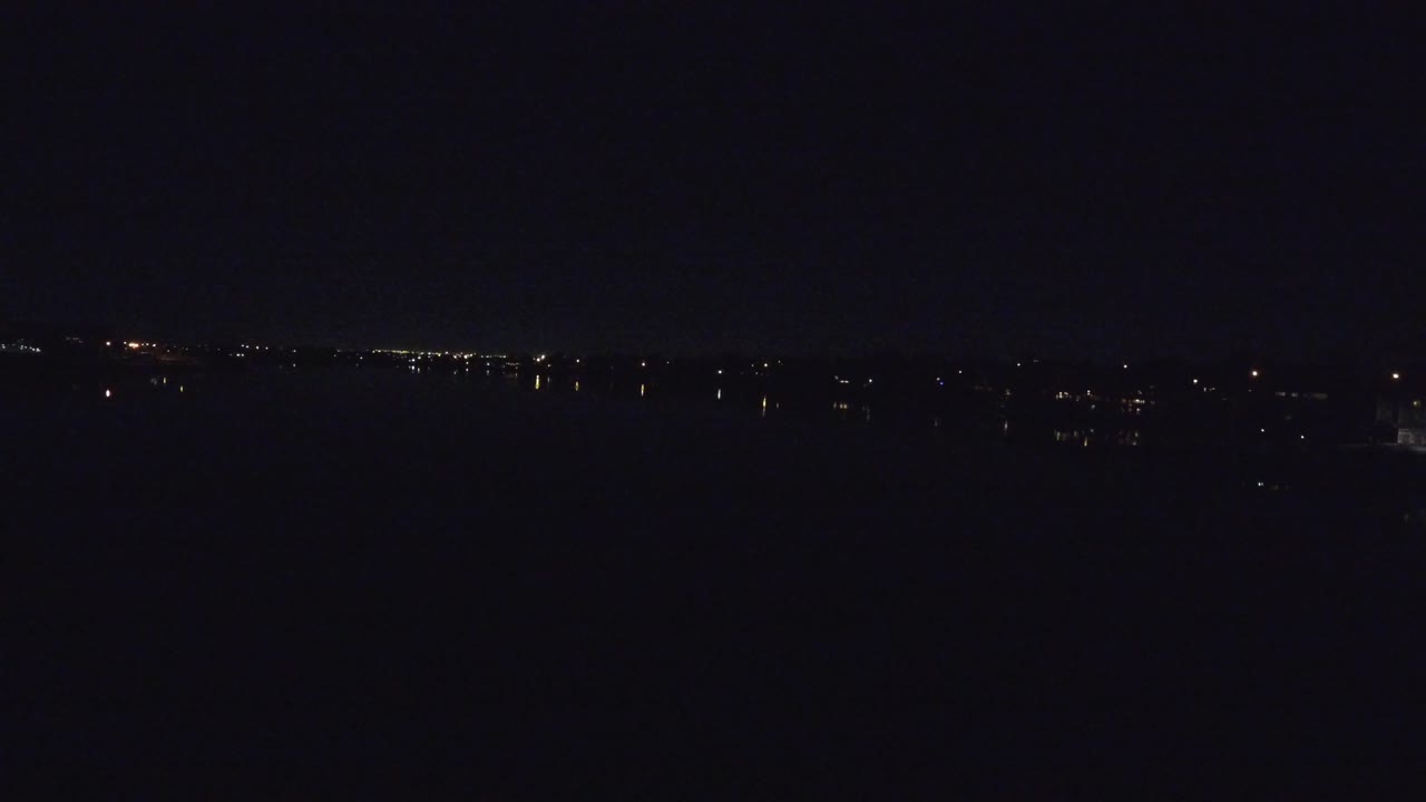 Denver, Colorado night aerial frame with a thin line of small lights across the upper frame and no visible people.