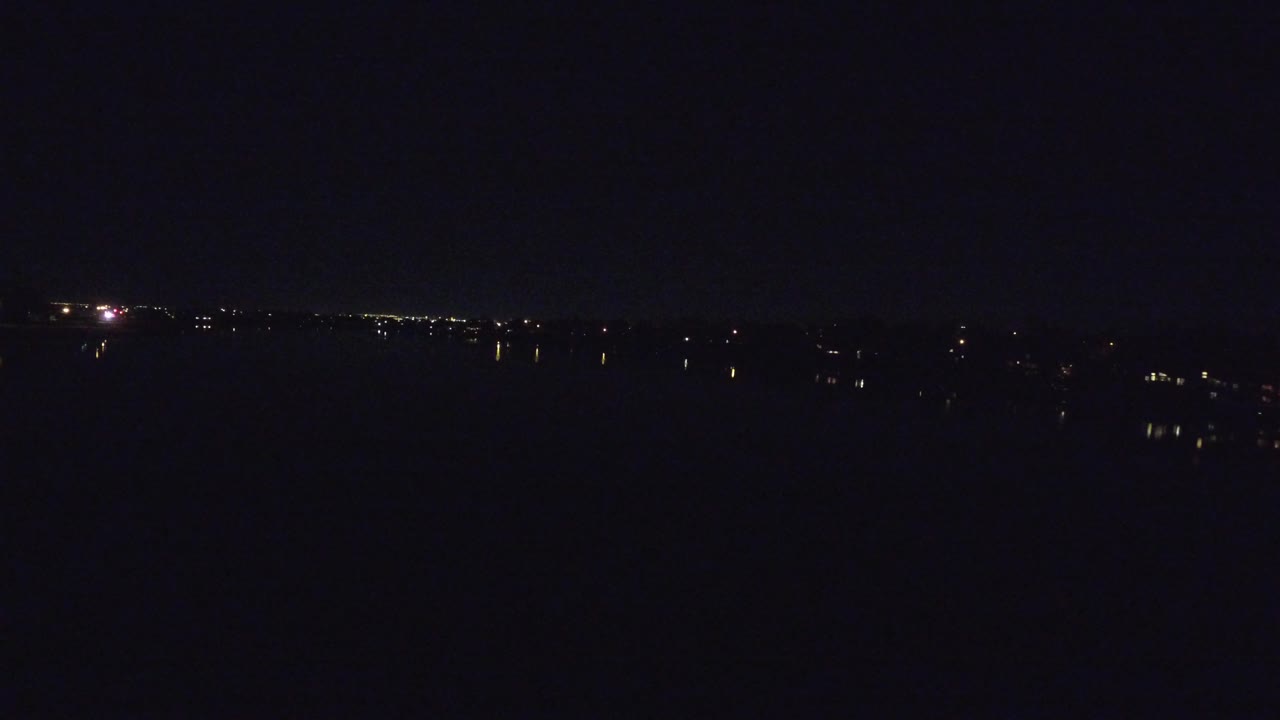 Very dark night view with a thin line of distant lights