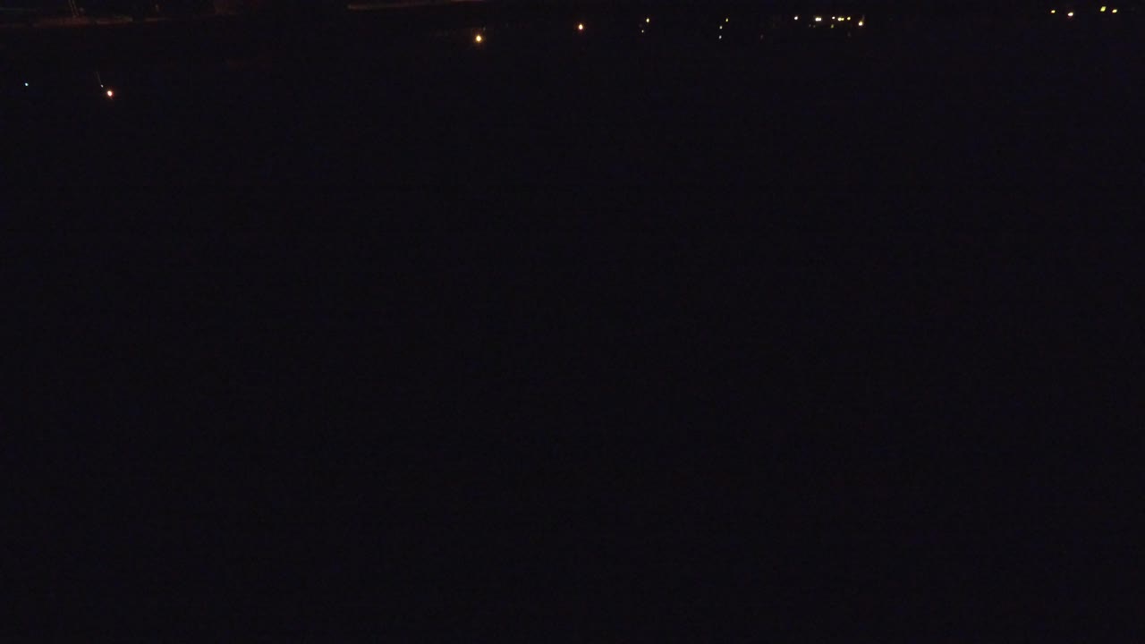 Dark aerial street view with scattered night lights