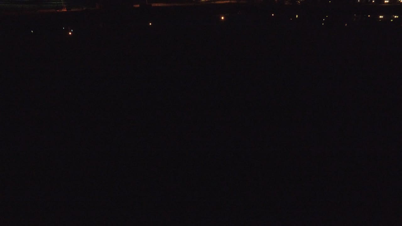 Denver, Colorado frame with a mostly black field, a few distant warm lights along the upper edge, and no visible people.
