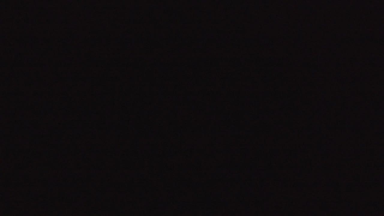 Almost black frame with subtle uneven exposure.