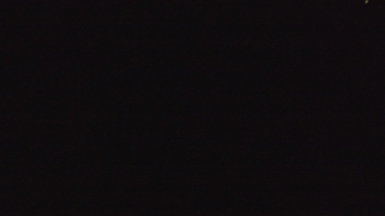 Nearly black frame with faint specks and soft blur