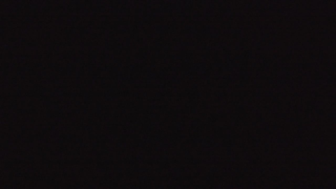 Nearly black frame with no visible subject detail