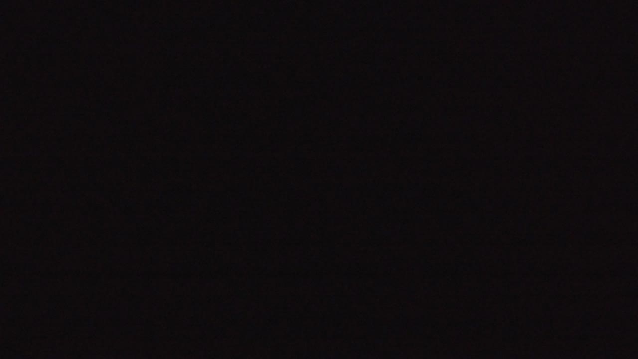 Nearly black screen with faint digital noise.