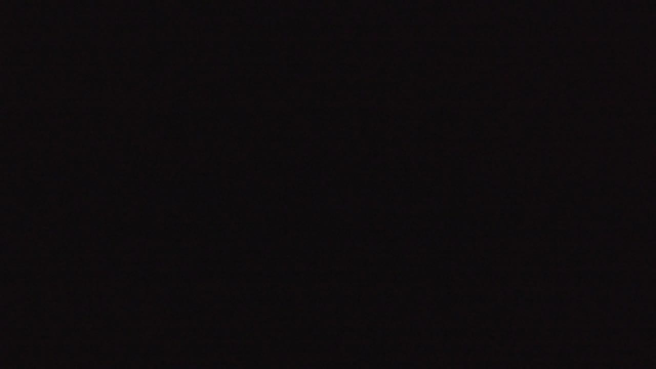 Dark low-light frame with slight tonal noise.