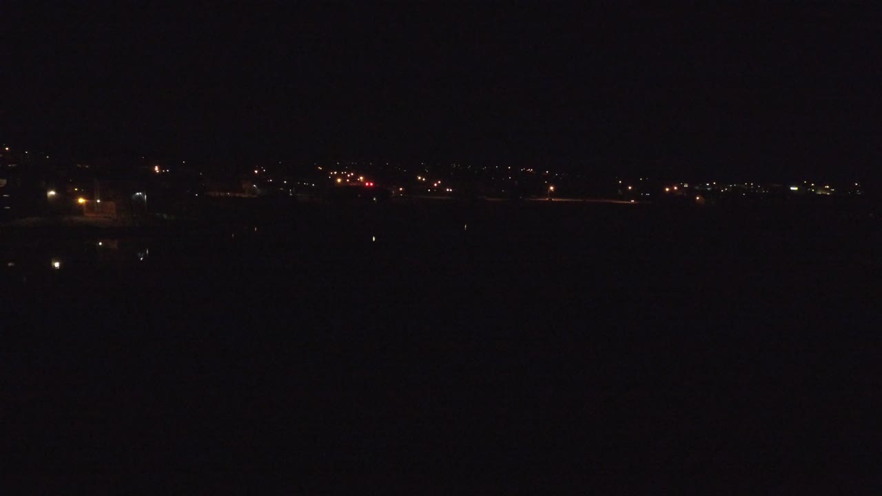 Dark night horizon with scattered distant lights