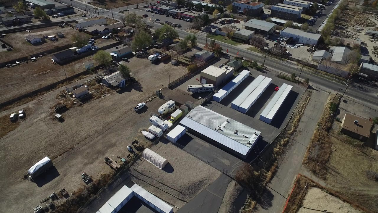 Aerial view of storage buildings and dirt lots beside roads