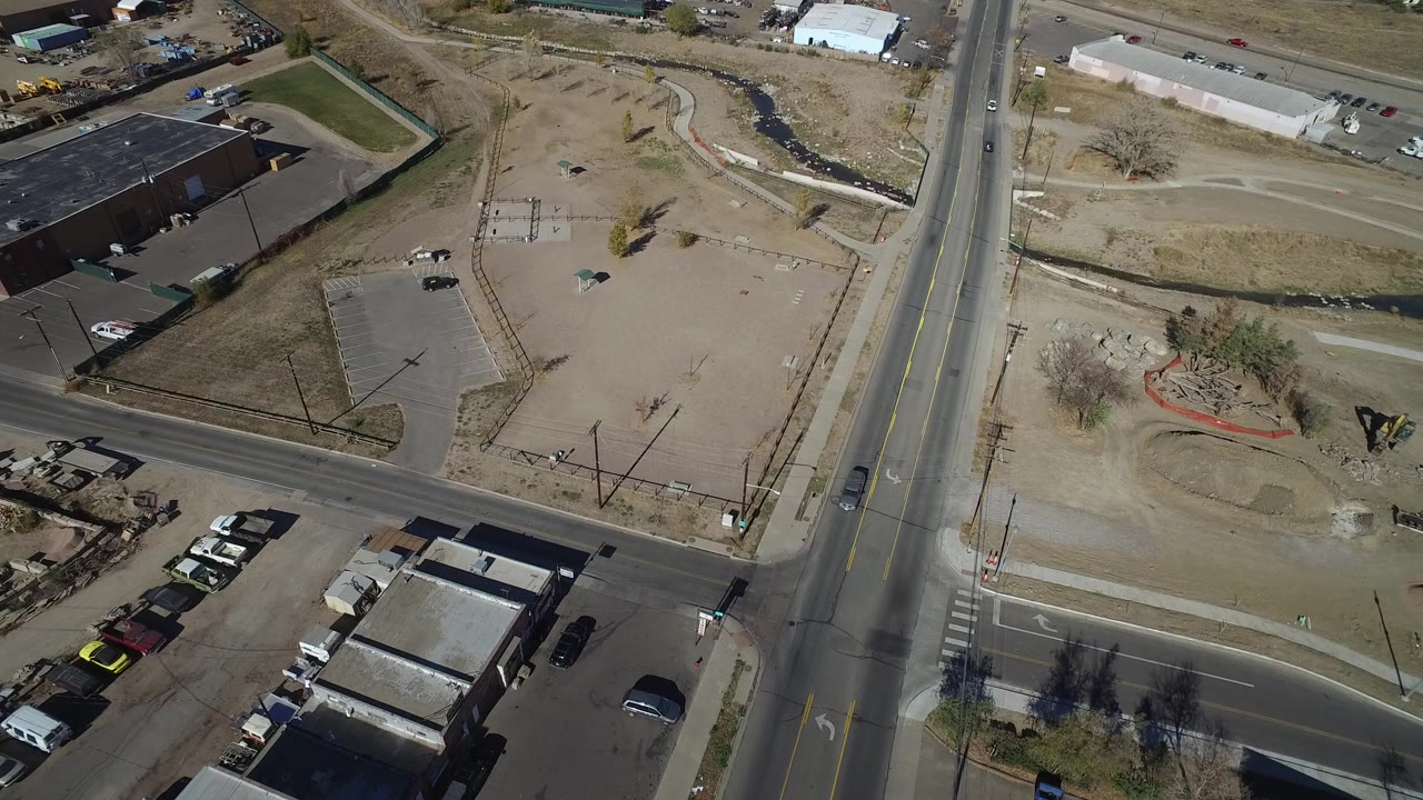Aerial view of an industrial intersection beside vacant dirt lots.
