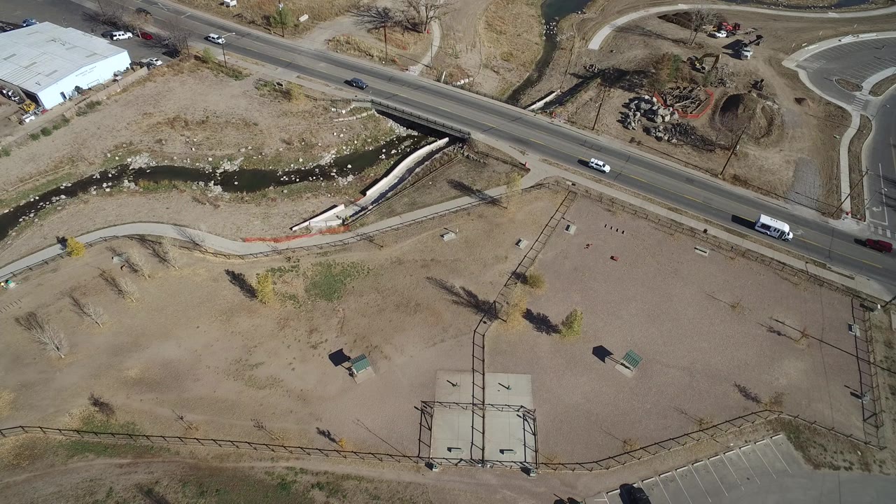 Drone view of a road crossing a dry open area with paths.