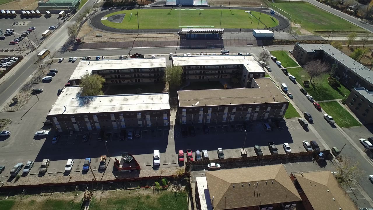 Aerial view of two large buildings beside streets and parking lots