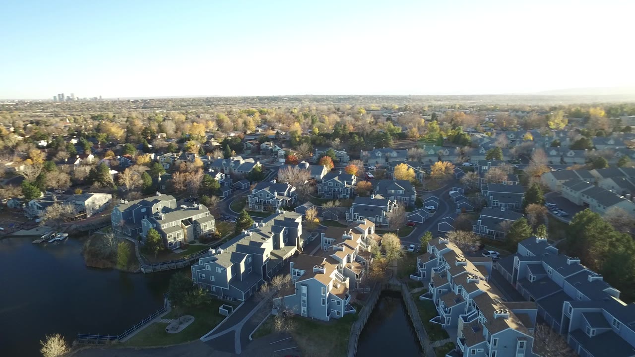 Suburban lake neighborhood seen from above in bright daylight.