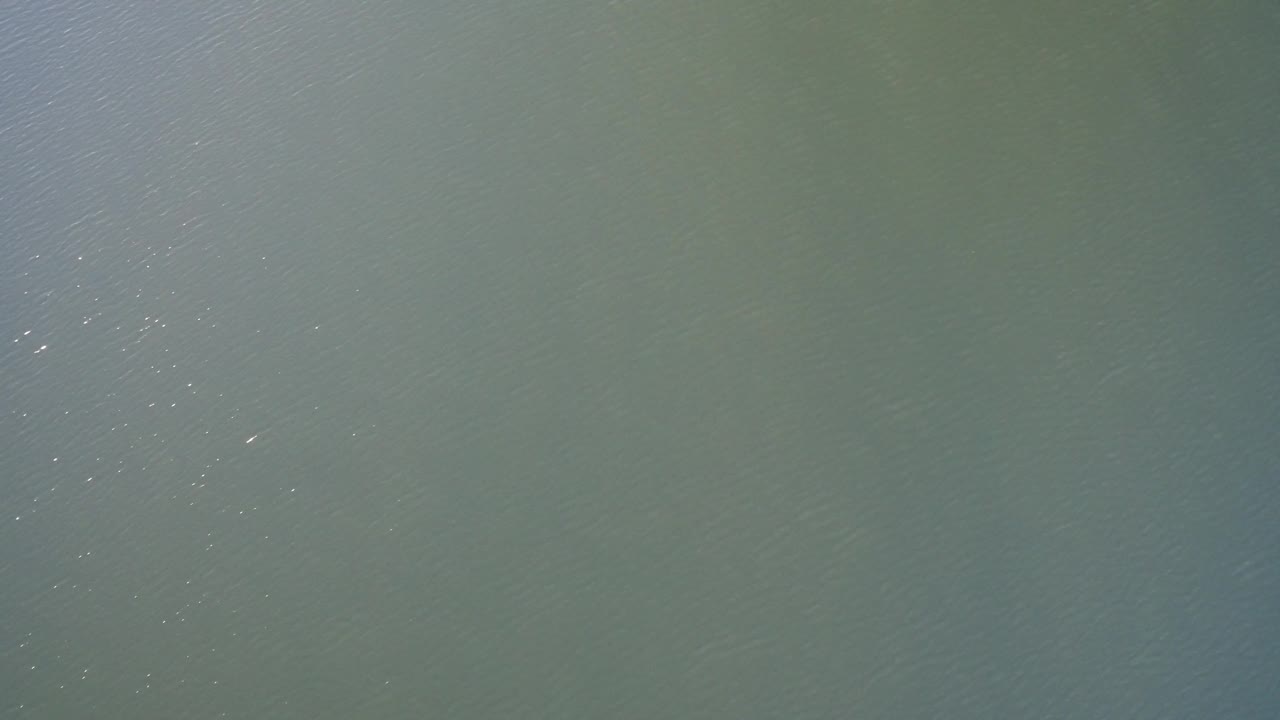 Open Westminster, Colorado water surface with diagonal ripple lines, muted green-blue color, and no visible people.