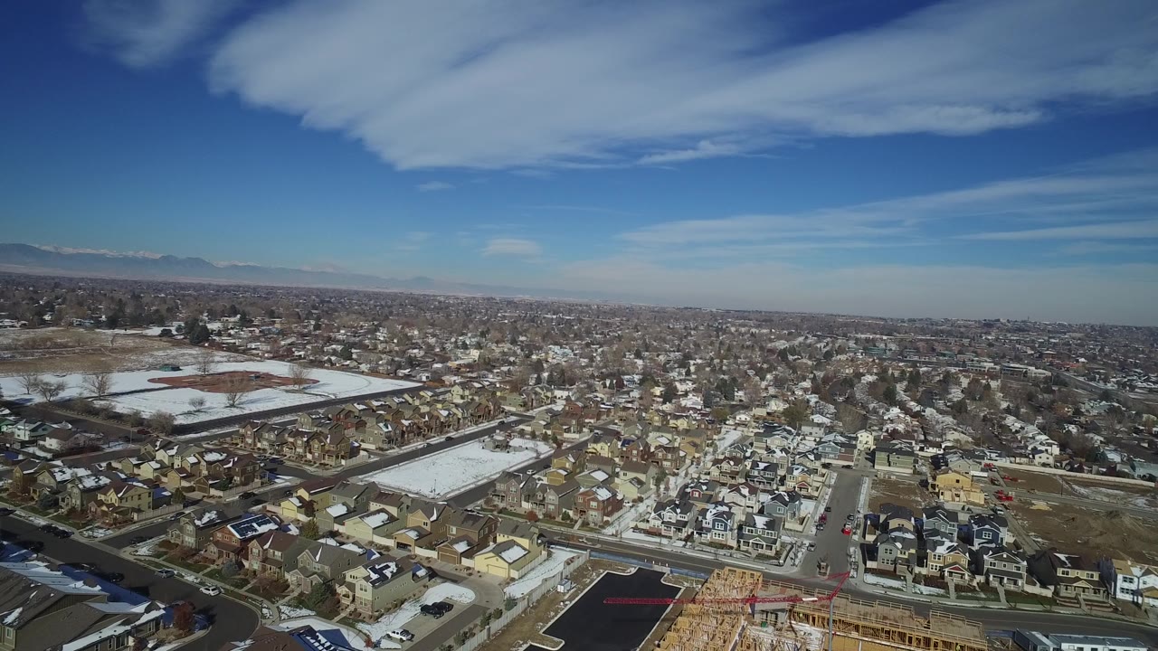 Hidden Lake, Colorado appears from a high aerial angle with rows of houses, open snowy lots, paved streets, and no visible people.