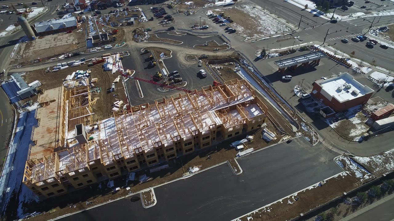 Overhead view of a partially built structure with adjacent streets and snow patches.