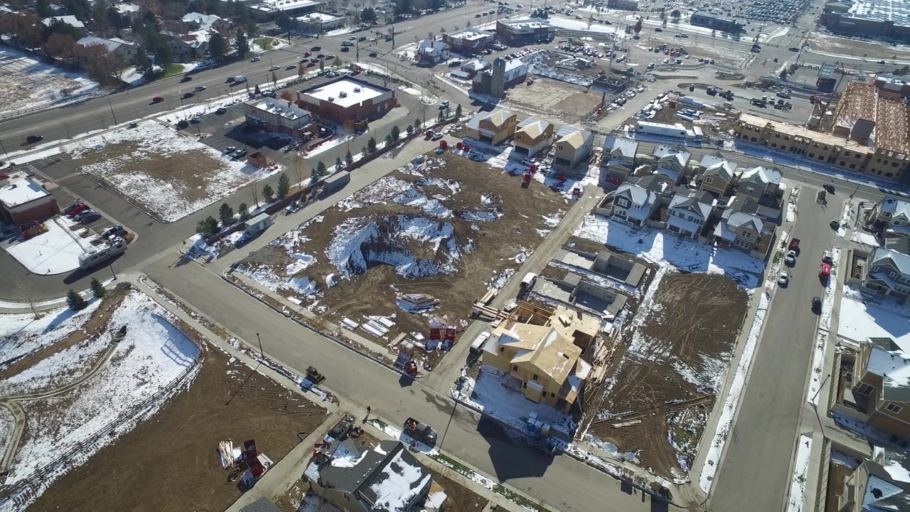 Aerial view of snow-dusted suburban homes and streets.