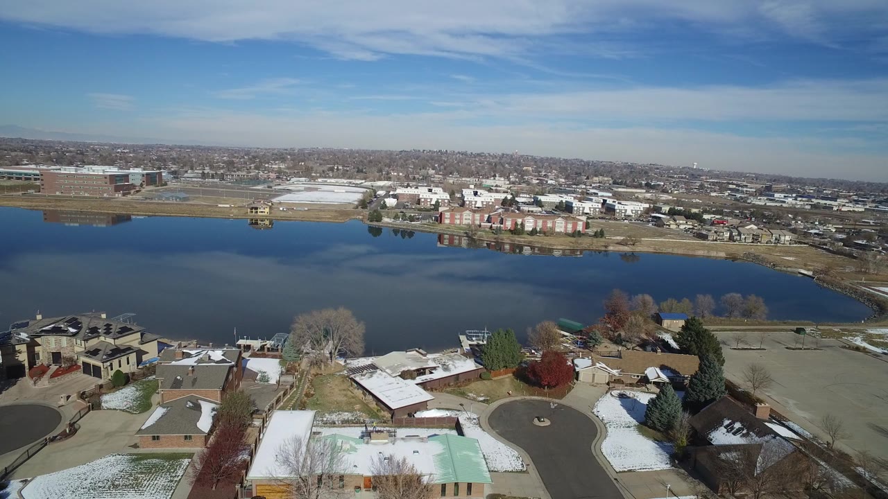 Aerial view of lakefront homes and large buildings across the water