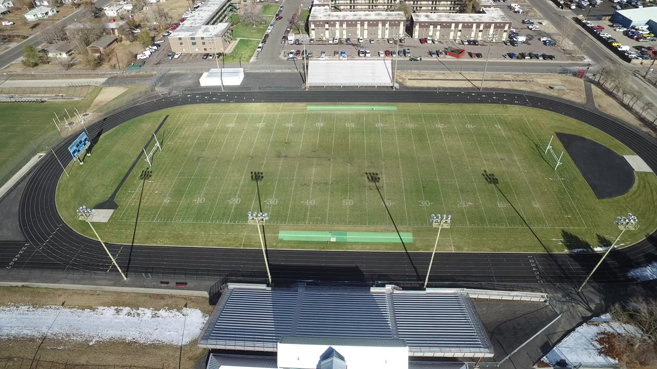 Aerial view of an empty football field inside a running track.