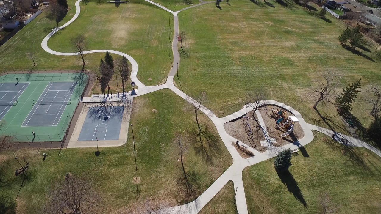 Aerial view of tennis courts, paths, lawn, and playground