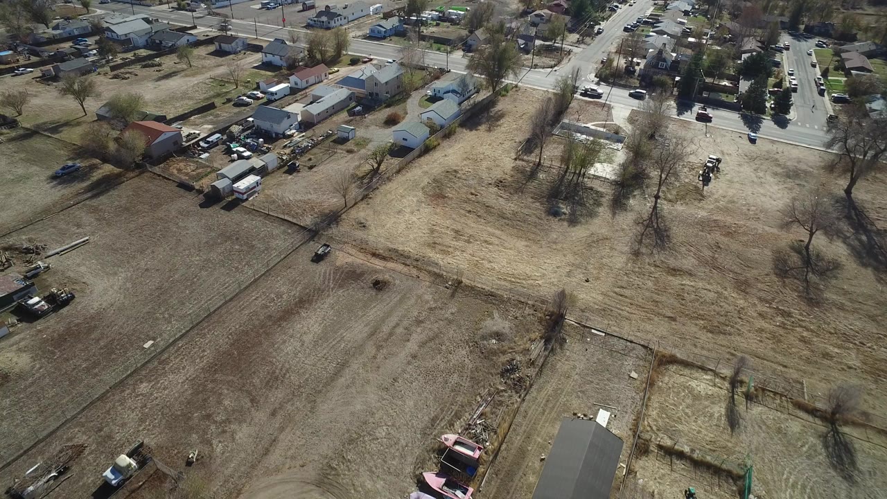 Aerial view of dry lots, houses, trees, and roads