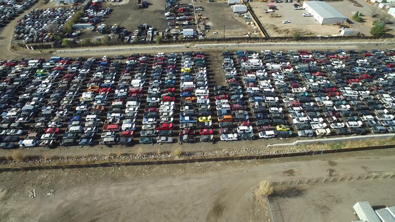 Aerial view of dense rows of parked cars in an open lot.