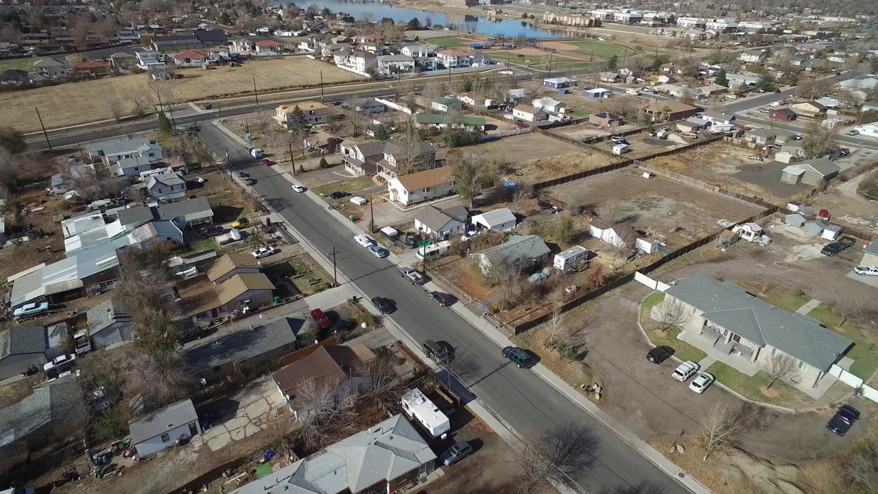 Aerial view over a suburban road and houses