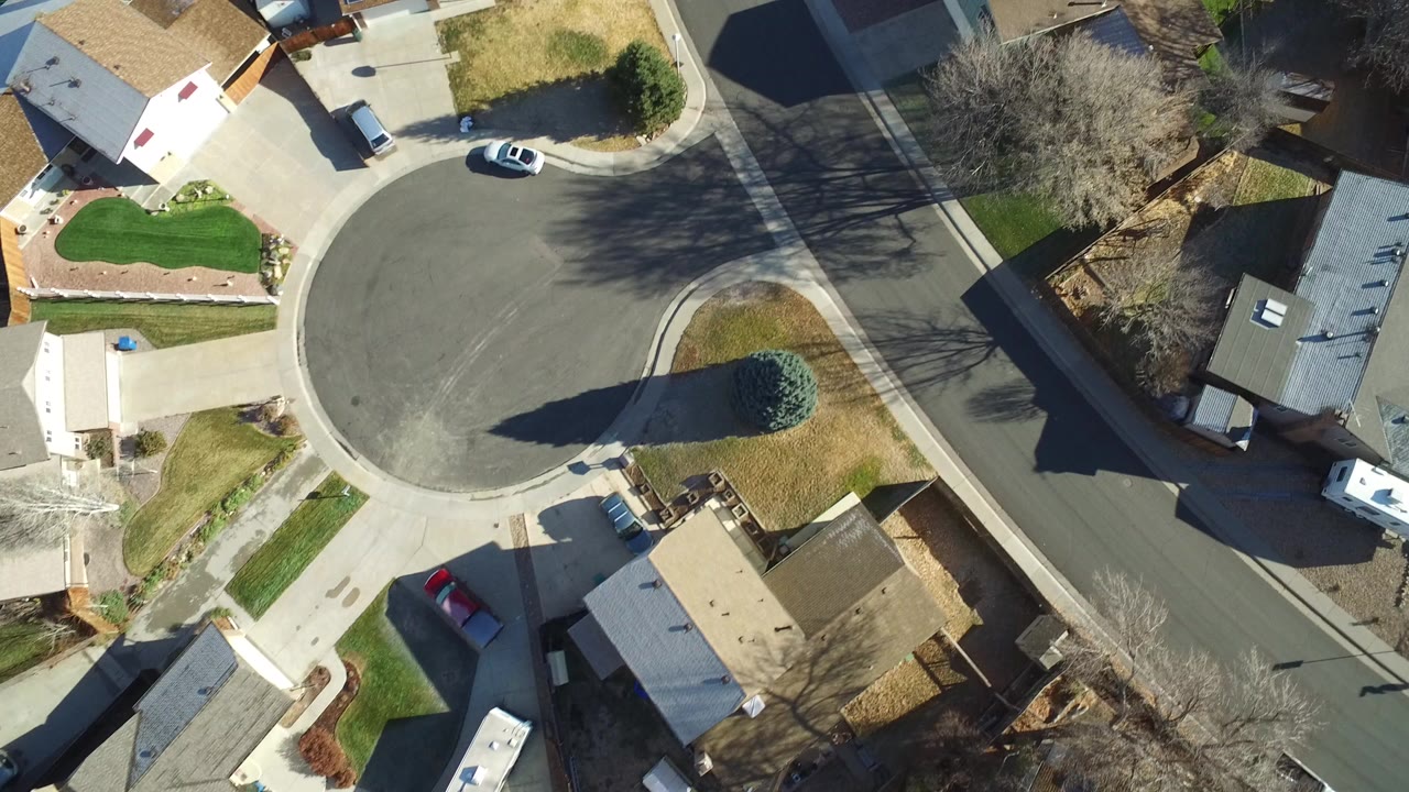 Overhead view of a suburban cul-de-sac and surrounding houses.