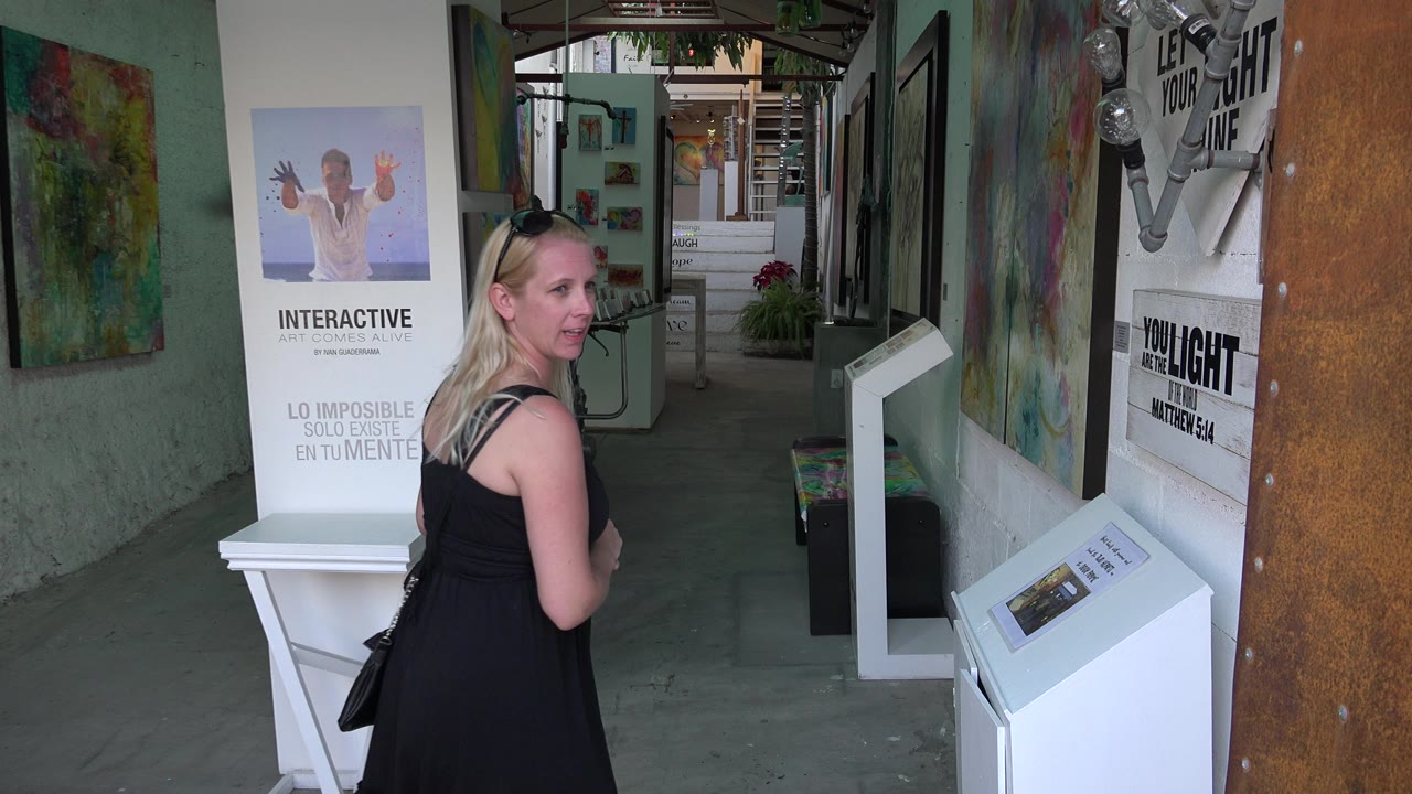 Blonde woman near a shop entrance with posters and display stands