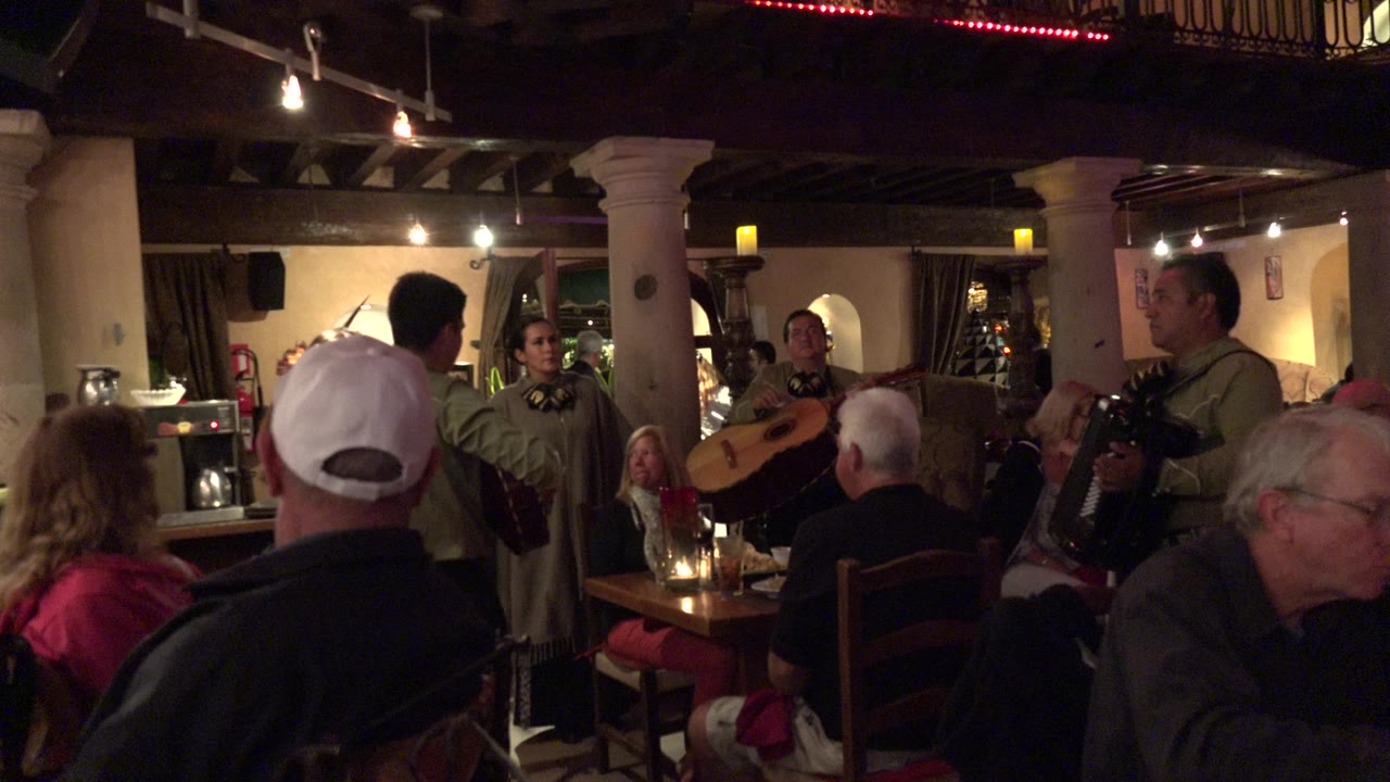 Pub audience watching musicians perform indoors