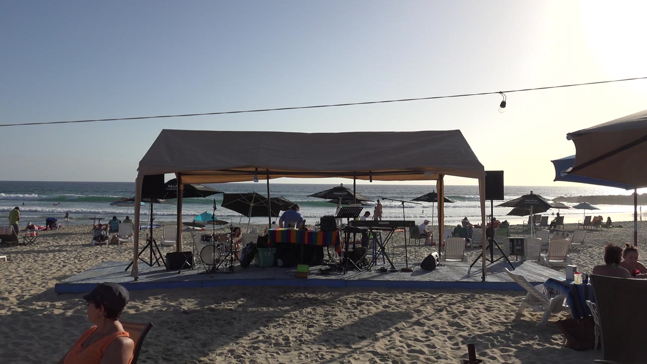 Beach canopy with music equipment facing the ocean