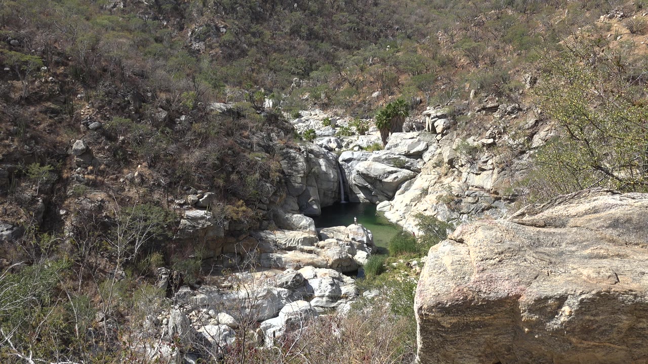 Distant creek and light rocks in dry ravine