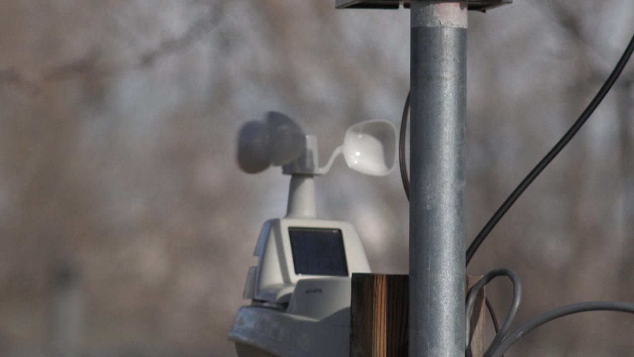 At 0:01, the wind sensor paddles have shifted position above the compact box beside the metal pole in Westminster, Colorado, with no visible people.