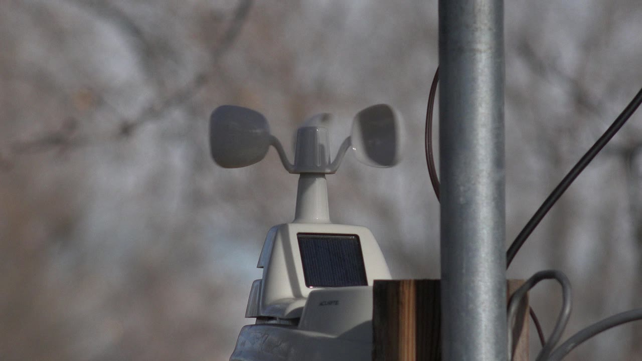The anemometer cups appear in a slightly different rotation above the solar panel, with cables and a metal pole cutting through the Westminster, Colorado frame and no visible people.
