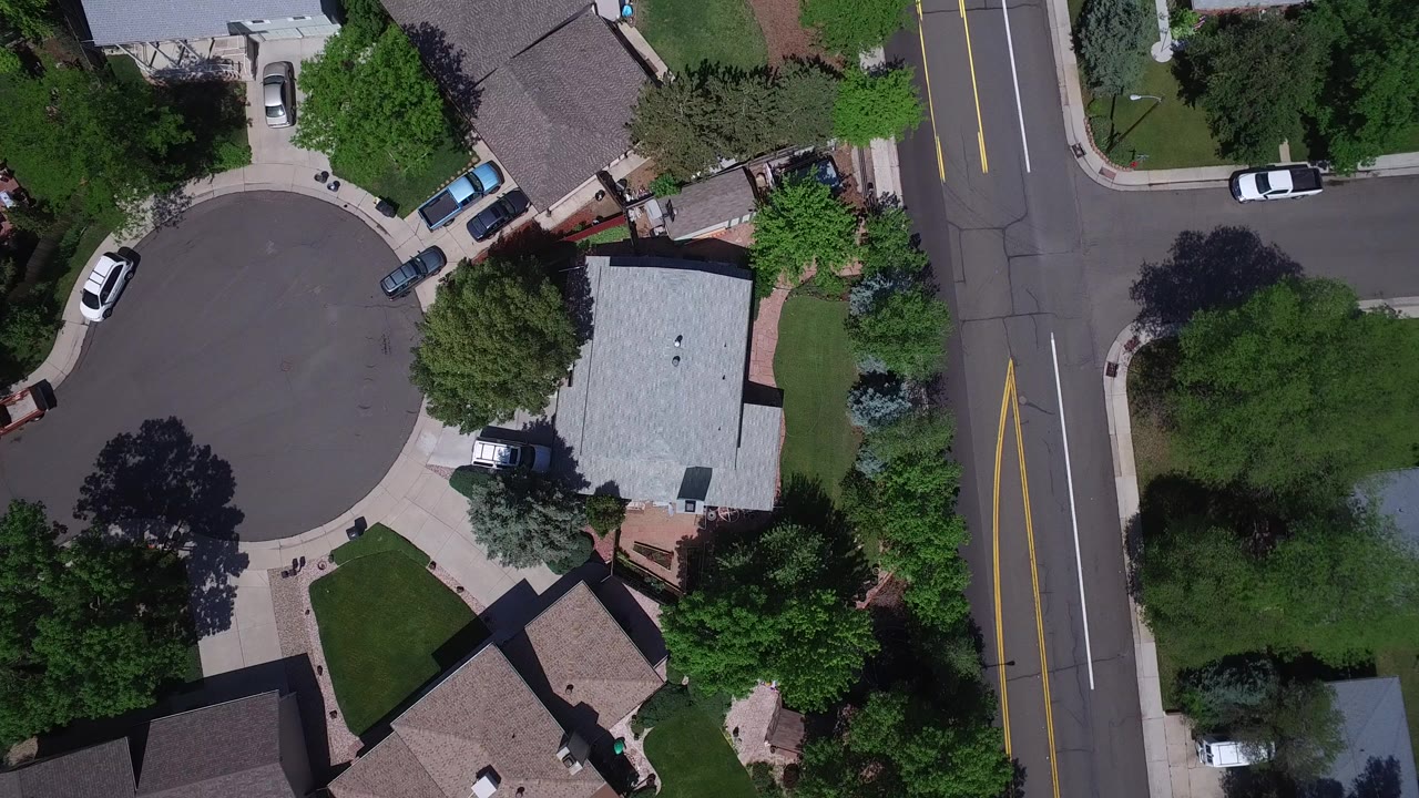 Overhead view of a cul-de-sac beside a two-lane residential road.