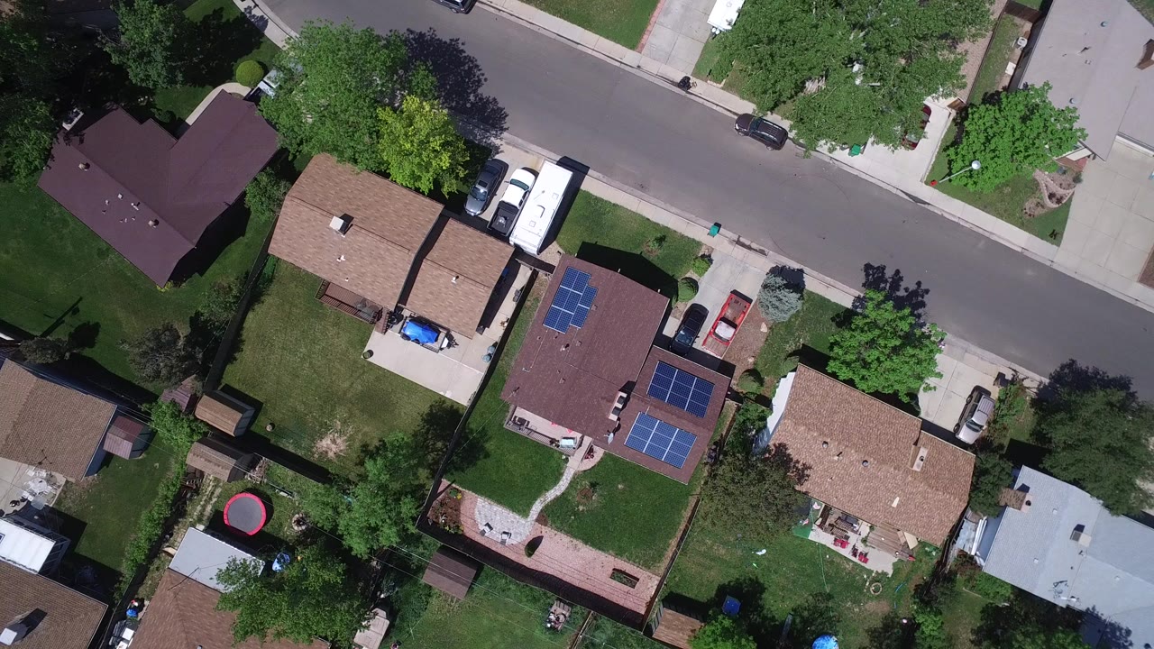 Overhead view of suburban homes along a residential street.