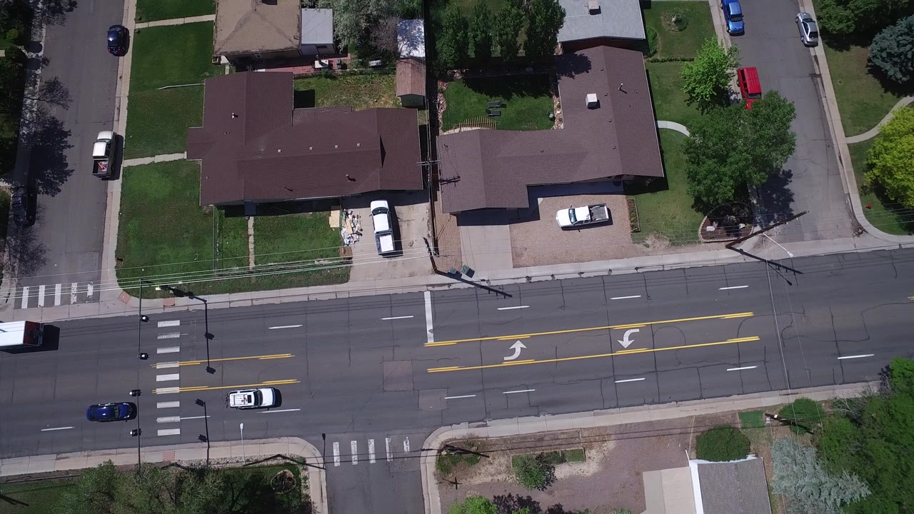Overhead view of a residential intersection and five-lane road