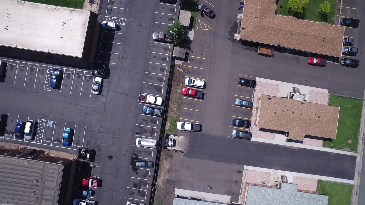 Overhead parking lots and tan-roofed buildings with parked cars