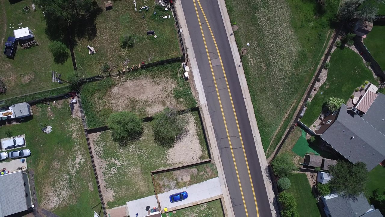 Top-down neighborhood view with road and residential yards