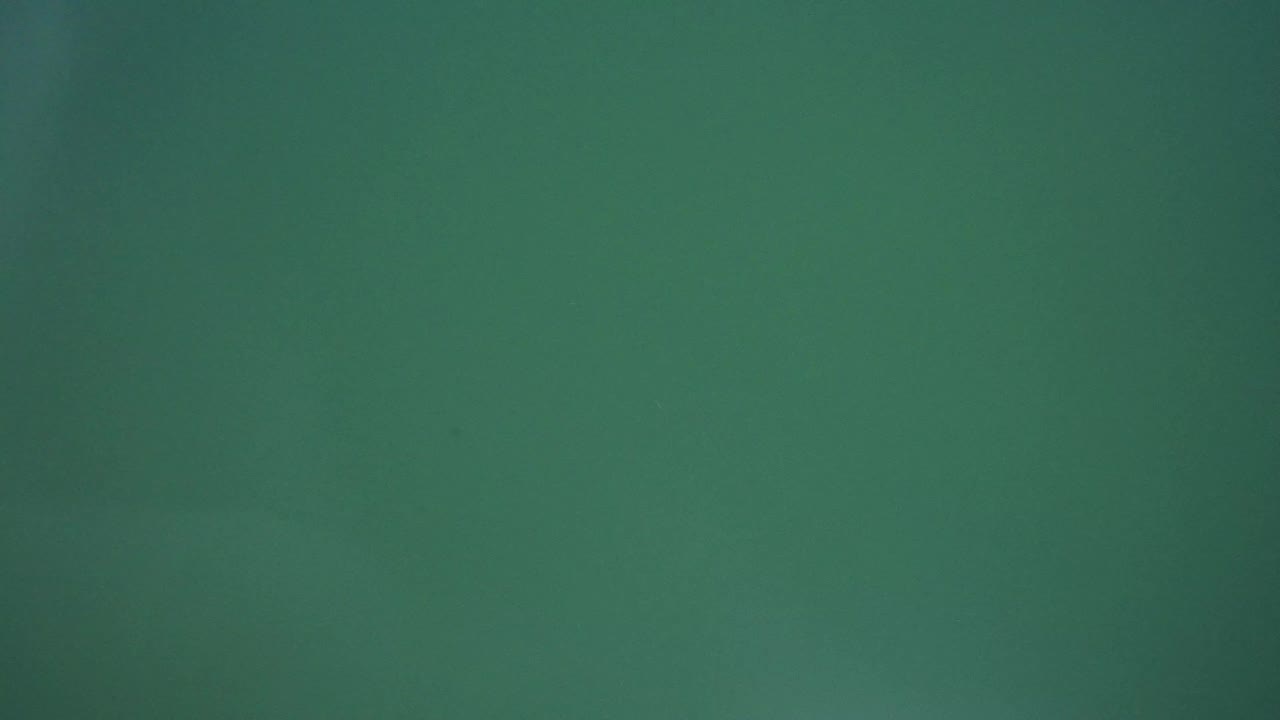 Westminster, Colorado frame with a bright white circular light glowing near the lower right area against a flat green background, with no visible people.