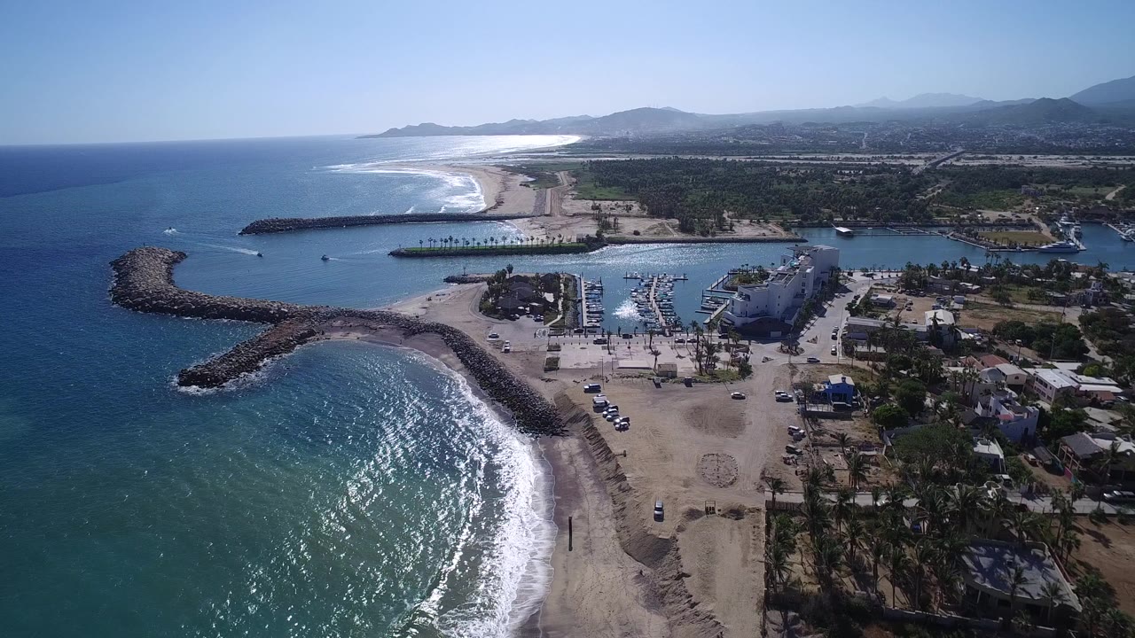 Elevated view of beach, breakwater, marina, and coastline