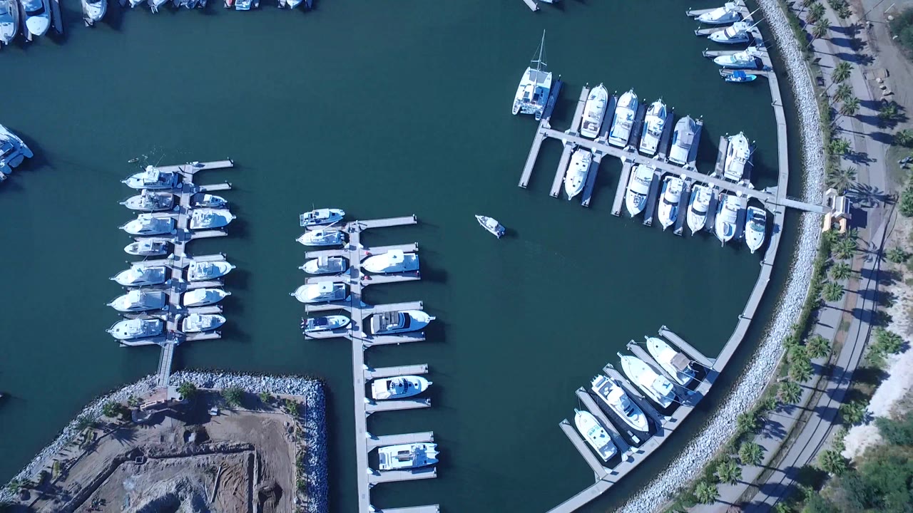 Marina basin with boats, docks, and rocky waterfront edge
