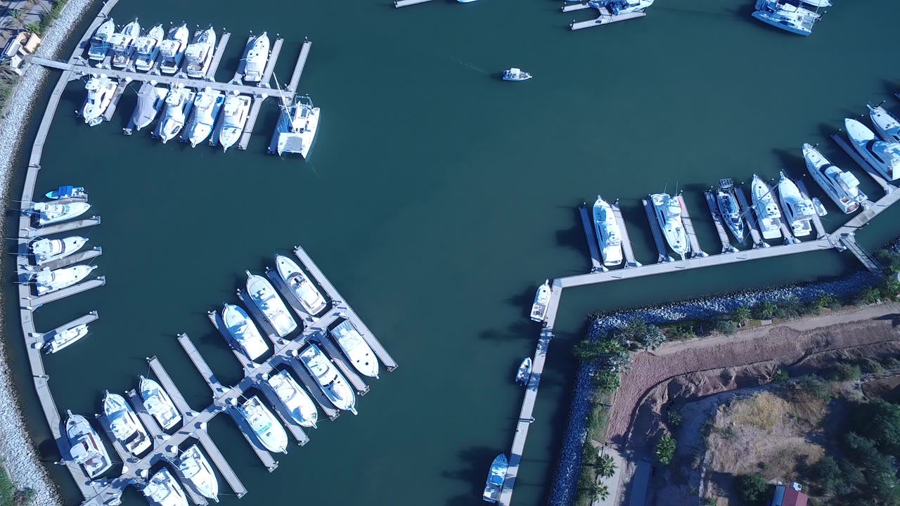 Overhead marina docks with white boats and teal water