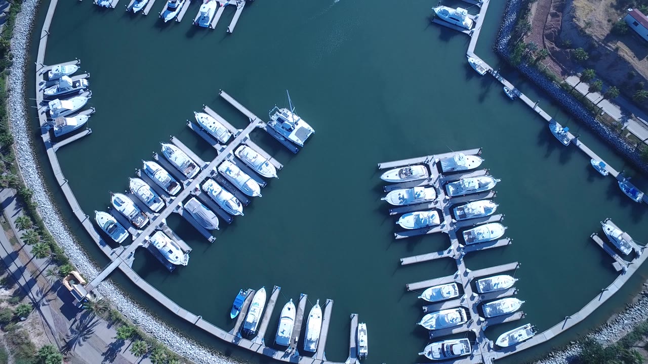 Top-down marina docks with clustered boats and dark water