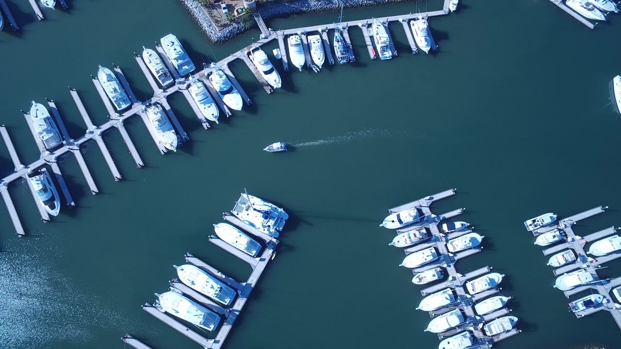 Aerial view of marina slips with boats aligned along docks.