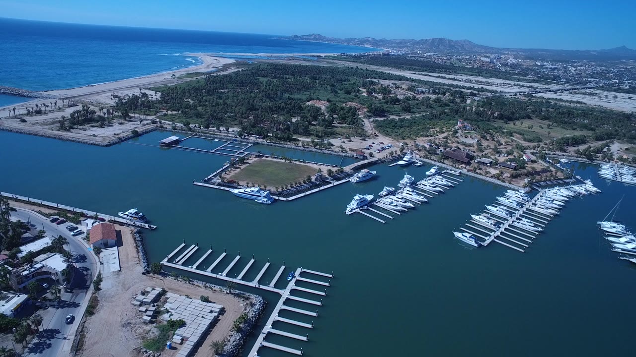 Aerial marina beside beach and coastal city