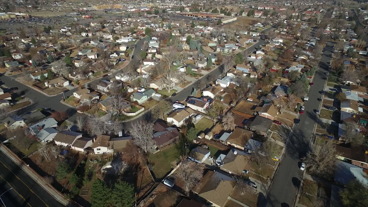 Aerial view over suburban houses and intersecting streets