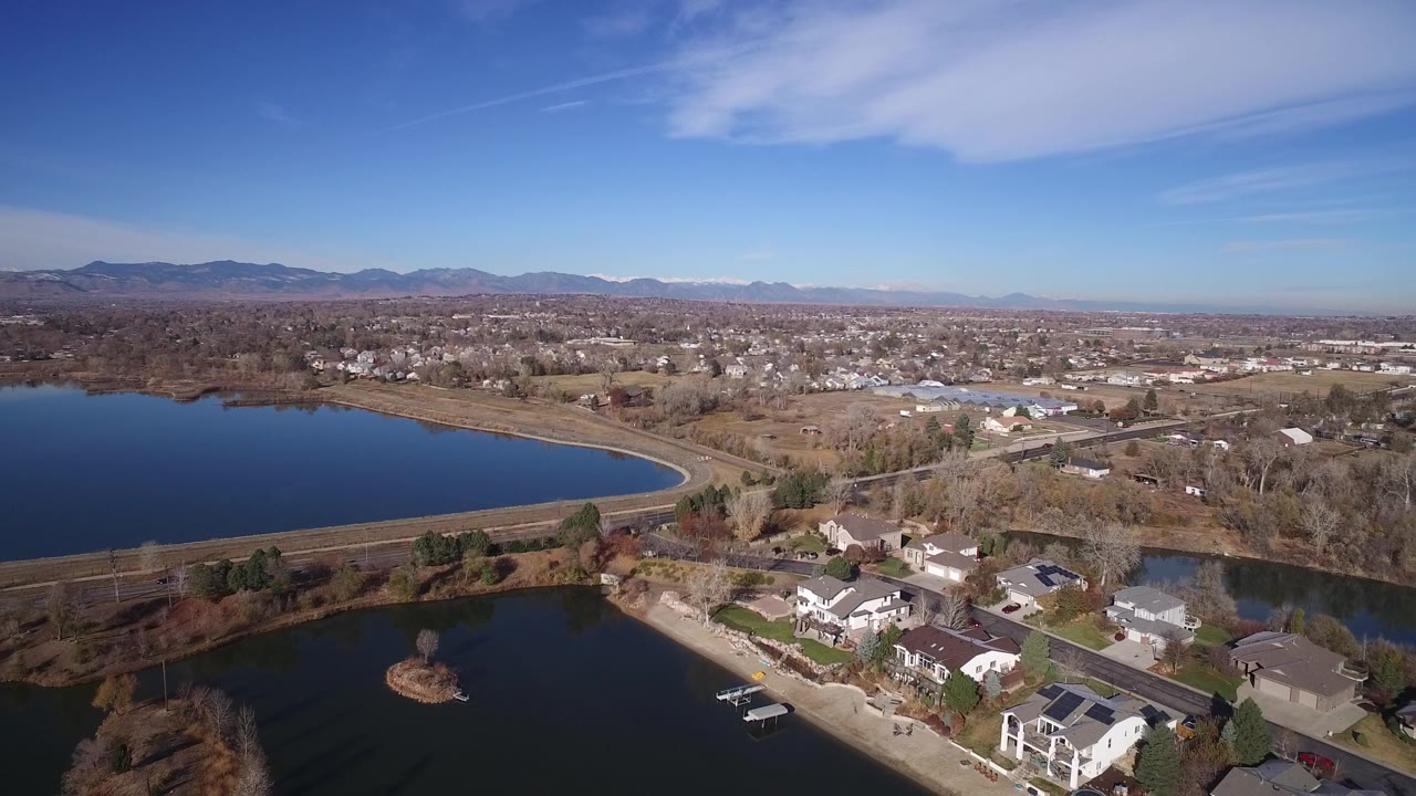 Aerial view of suburban homes beside two bodies of water.