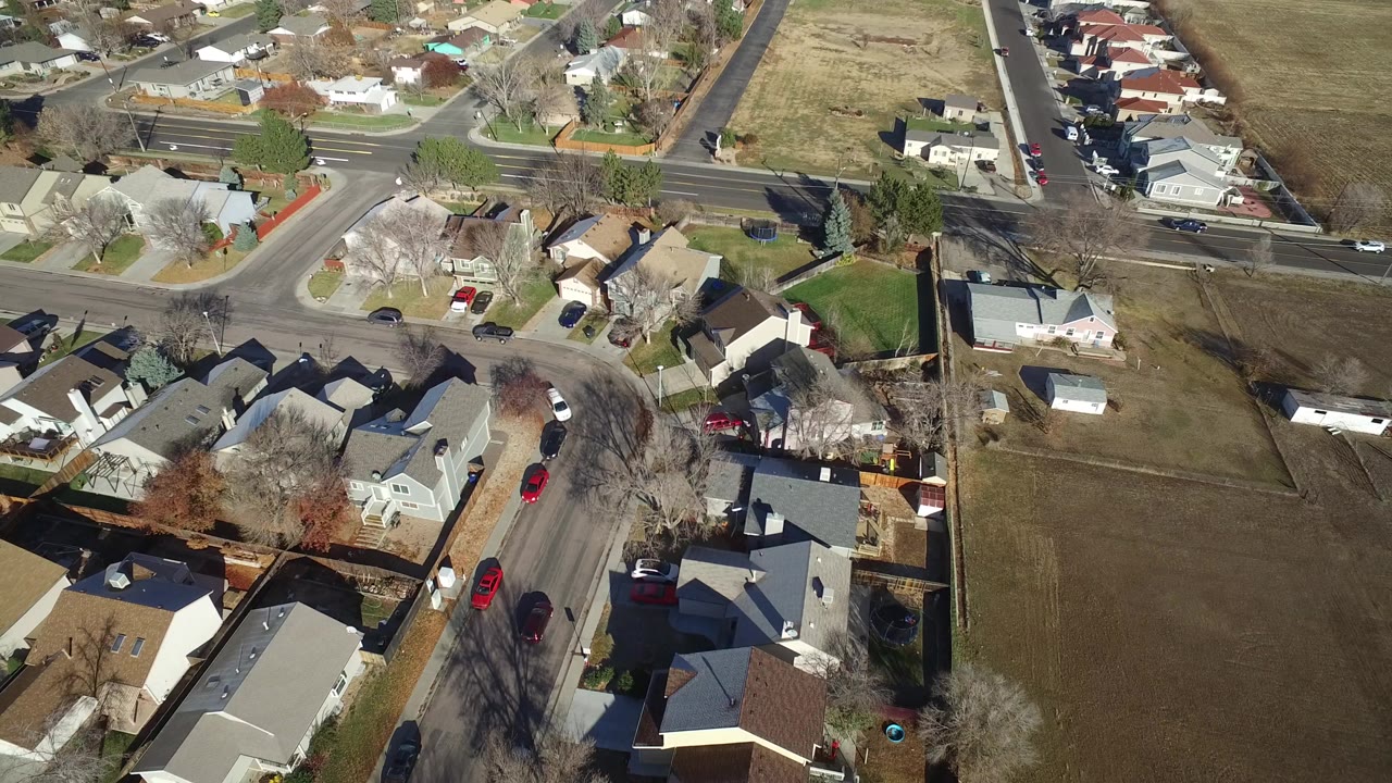 Aerial view of suburban houses and intersecting residential streets.