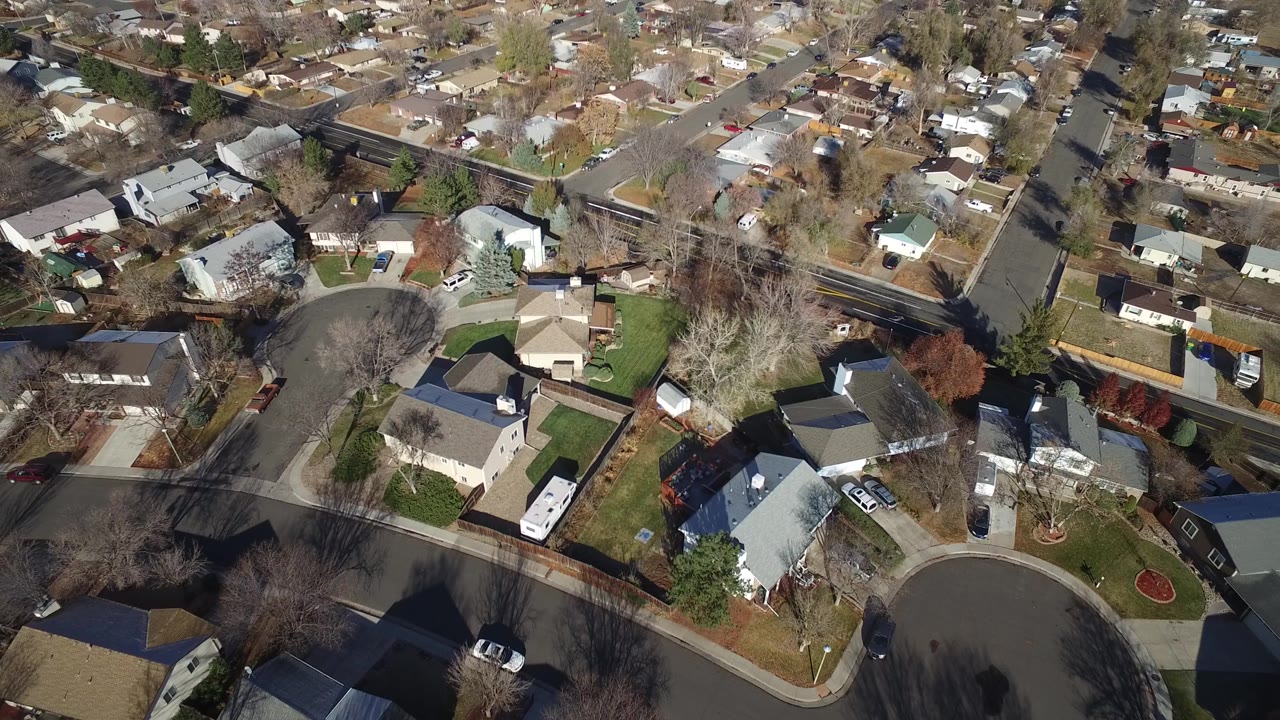 Top-down neighborhood view with houses and a cul-de-sac edge.